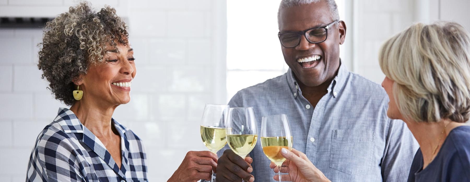 a few people toasting wine glasses