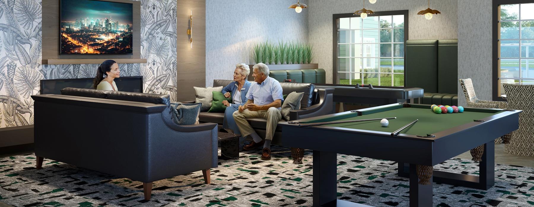 a group of people sitting on a couch in a room with a large screen and a pool table