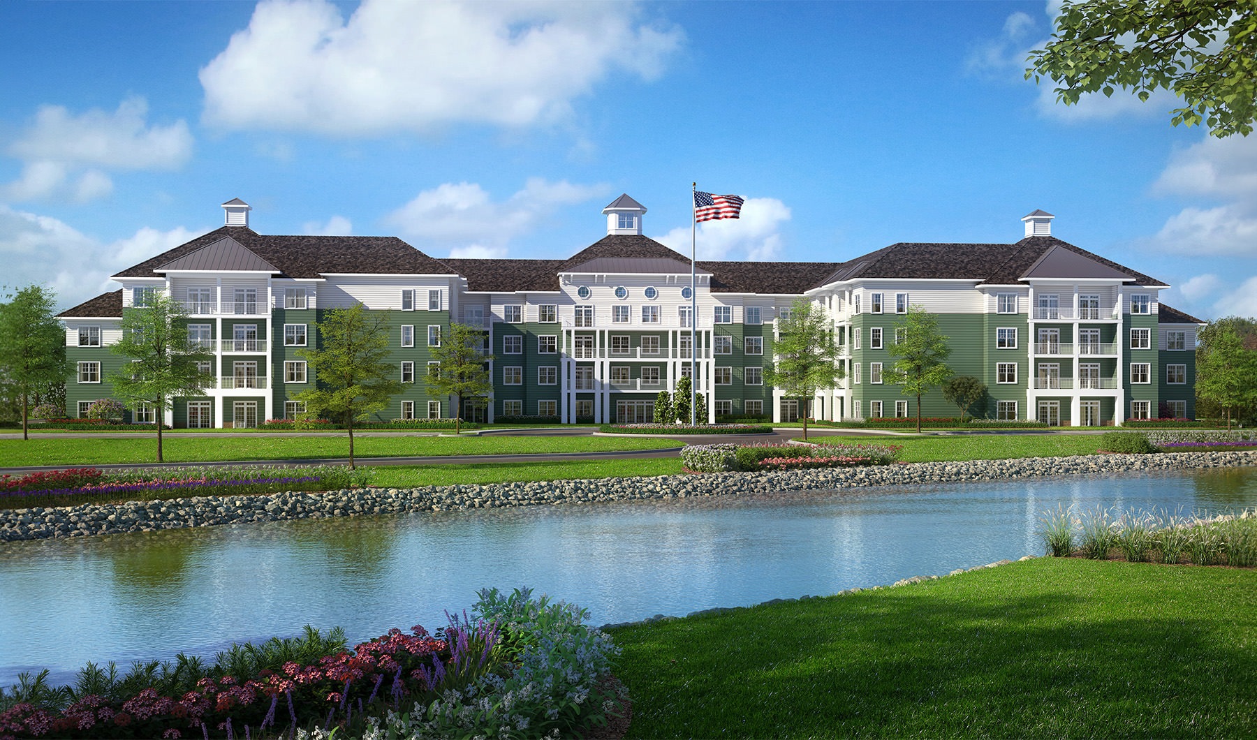 a building with a large river and green grass in front of it